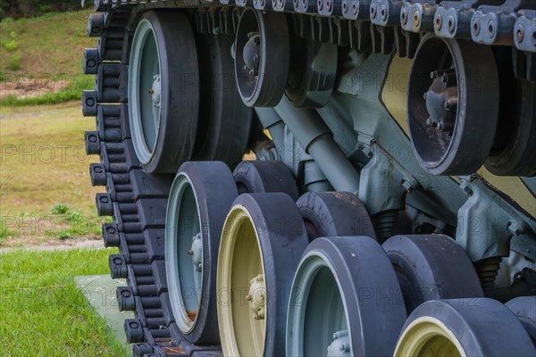 Closeup of wheels and track of military tank on display in public park in Nonsan, South Korea, Asia