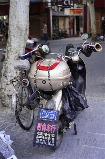 Shanghai, China, Asia, Parked scooter and bicycle on a roadside with parking signs in Chinese, People's Republic of China, Asia