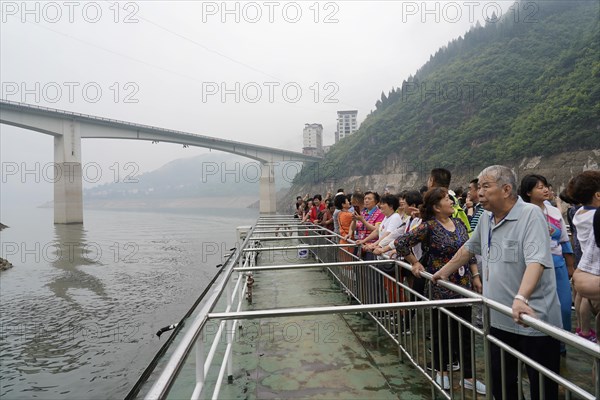 Cruise ship on the Yangtze River, Hubei Province, China, Asia, tourists stand at the railing of a boat and look at a misty river and mountains, Yichang, Asia