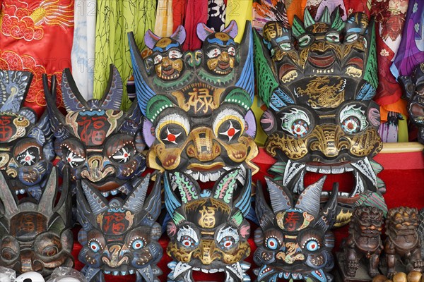 Chongqing, Chongqing Province, souvenirs, stall, on the Yangtze River, masks with elaborate paintings and carvings on display, traditional handicrafts, Yangtze River, Chongqing, Chongqing Province, China, Asia