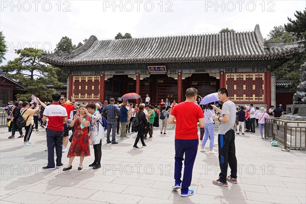 New Summer Palace, Beijing, China, Asia, A group of tourists visits a temple with traditional architecture on a sunny day, Beijing, Asia