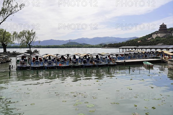 New Summer Palace, Beijing, China, Asia, Tourist boats on a lake with green water in front of a mountain backdrop, Beijing, Asia