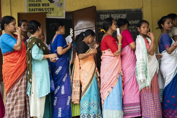 BOKAKHAT, INDIA, APRIL 19: Voters wait in line at a polling station to cast their votes during the first phase of the India's general elections on April 19, 2024 in Bokakhat, Assam, India. Nearly a billion Indians vote to elect a new government in six-week-long parliamentary polls starting today