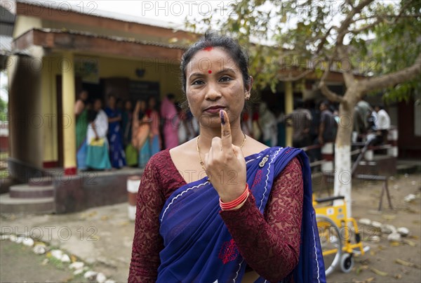 BOKAKHAT, INDIA, APRIL 19: A women show her marked finger after casting vote during the first phase of the India's general elections on April 19, 2024 in Bokakhat, Assam, India. Nearly a billion Indians vote to elect a new government in six-week-long parliamentary polls starting today