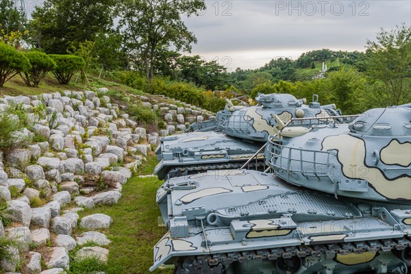 Closeup of gun turret on military tanks with camouflage paint on display in public park in Nonsan, South Korea, Asia