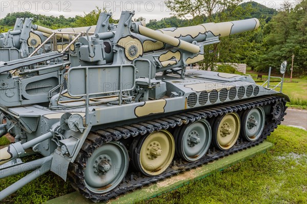 A camouflaged military artillery tank displayed outdoors at a museum, in Nonsan, South Korea, Asia