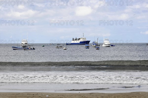 San Juan del Sur, Nicaragua, View of the sea with ships, waves in the foreground and expansive sky, Central America, Central America