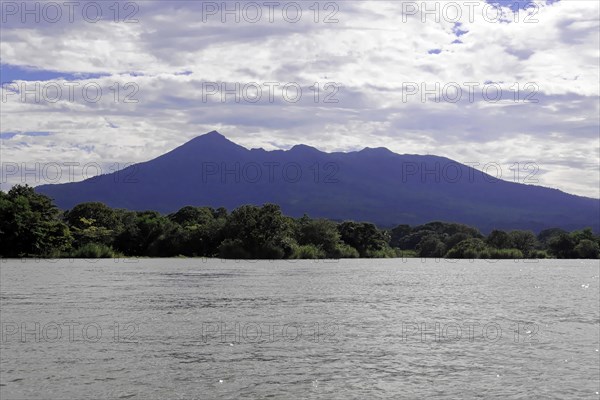 Granada, Nicaragua, Wide view of Lake Nicaragua in front of a mountain, spanned by a blue sky with clouds, Central America, Central America