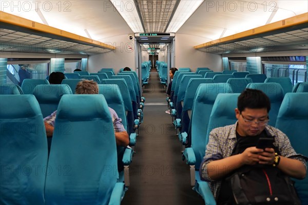 Shanghai Transrapid Maglev Shanghai Maglev Train Station Station, Shanghai, China, Asia, Interior view of a high-speed train with blue seats and travelling passengers, Asia