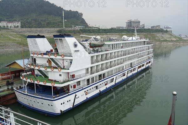 Cruise ship on the Yangtze River, Yichang, Hubei Province, China, Asia, A cruise ship at a dock near a rocky embankment, Shanghai, Asia