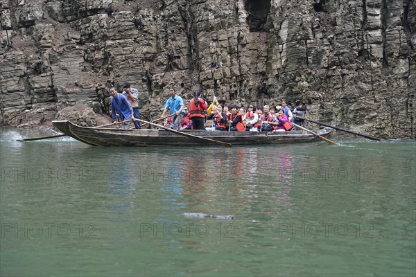 Special boats for the side arms of the Yangtze, for the tourists of the river cruise ships, Yichang, China, Asia, passengers in traditional clothes on a boat surrounded by rocks, Hubei province, Asia