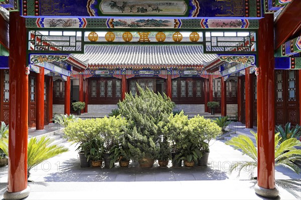 Chongqing, Chongqing Province, China, Asia, Inner courtyard of a Chinese building surrounded by traditional galleries and plants, Asia
