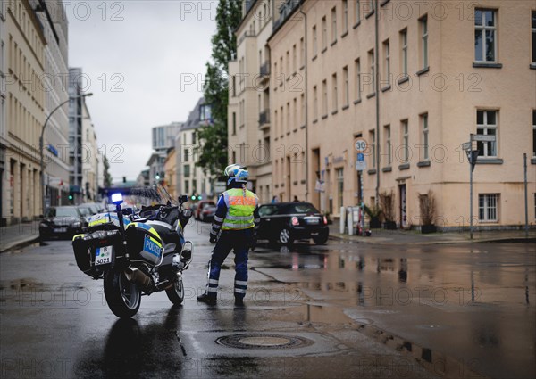 Policewoman with motorbike blocks road, taken during a demonstration in Berlin, 19/04/2024