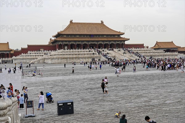 China, Beijing, Forbidden City, UNESCO World Heritage Site, visitors walk across a large square in the Forbidden City under an overcast sky, Asia