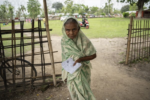 BOKAKHAT, INDIA, APRIL 19: An elderly woman arrives at a polling station to cast her vote during the first phase of the India's general elections on April 19, 2024 in Bokakhat, Assam, India. Nearly a billion Indians vote to elect a new government in six-week-long parliamentary polls starting today