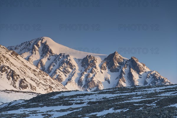 Sunrise at the snowy Cold Peak, Mongolian Chueiten, 3373m, Tavan Bogd National Park, Mongolian Altai Mountains, Western Mongolia, Mongolia, Asia