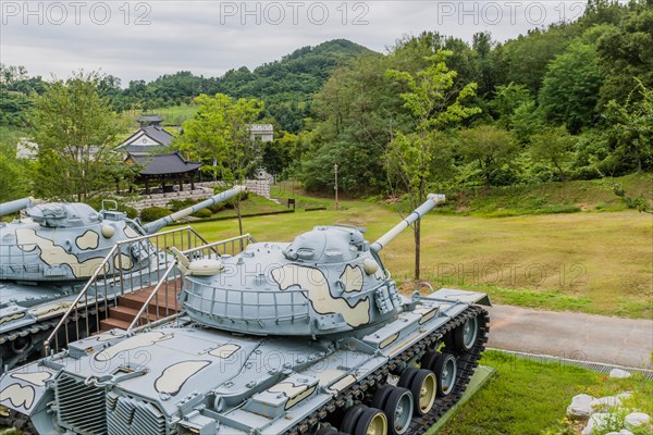 Closeup of military tanks with camouflage paint on display in public park near Nonsan, South Korea on overcast day