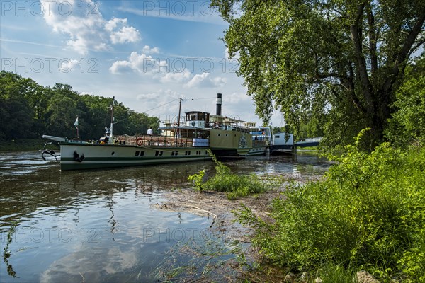 The historic paddle steamer KURORT RATHEN has docked at the steamer landing stage in Pillnitz, Dresden, Saxony, Germany, Europe