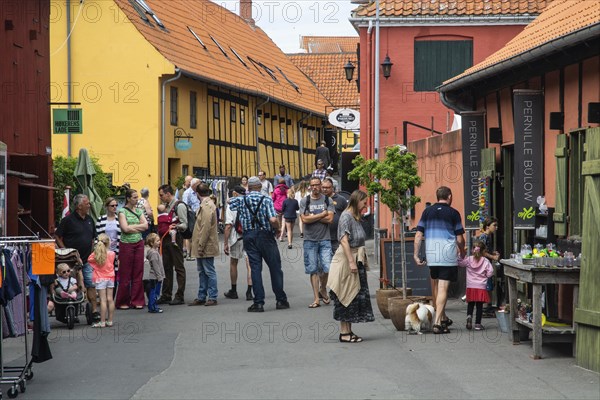People in a narrow street in Svaneke on the island of Bornholm, Baltic Sea, Denmark, Scandinavia, Northern Europe, Europe