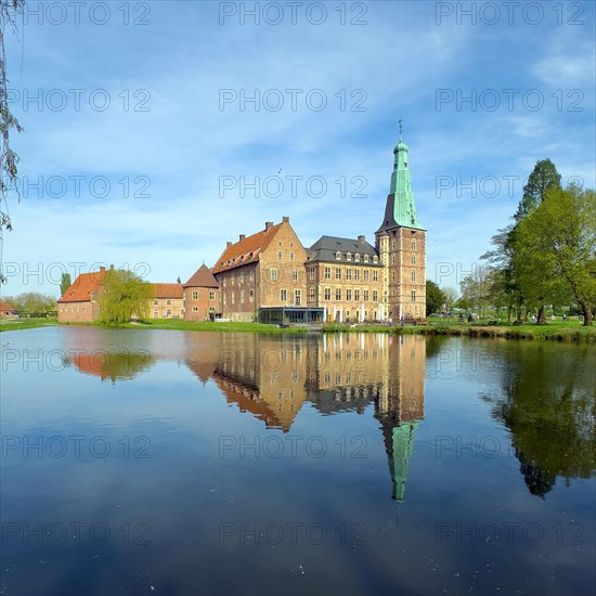 View over moat to historic moated castle from Renaissance Raesfeld Castle reflected in moat in spring, excursion destination in North Rhine-Westphalia, Freiheit Raesfeld, Muensterland, North Rhine-Westphalia, Germany, Europe