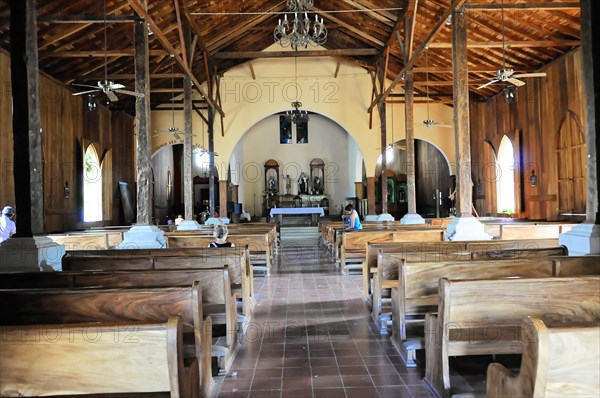 Church of San Juan del Sur, Nicaragua, Central America, View into the nave with wooden benches and stained glass windows, Central America