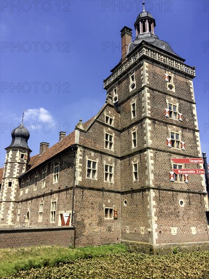 View of in the foreground Sterndeuterturm stands in moat around behind it on the left outer bailey of moated castle Schloss Raesfeld, excursion destination in North Rhine-Westphalia, Freiheit Raesfeld, Muensterland, North Rhine-Westphalia, Germany, Europe