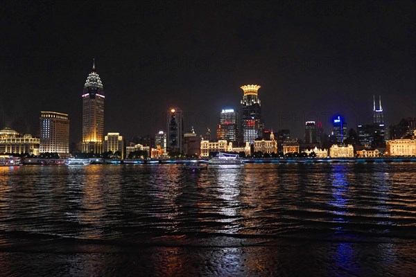 Skyline of Shanghai at night, China, Asia, Luminous skyline of a city reflected in calm water at night, Shanghai, People's Republic of China, Asia