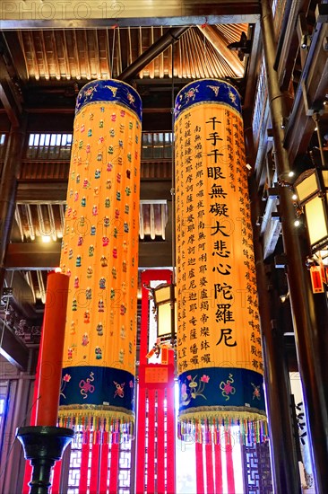 Jade Buddha Temple, Shanghai, Tall coloured columns with Asian characters in traditional wooden architecture, Shanghai, China, Asia