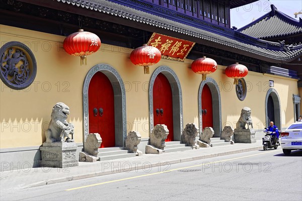 Jade Buddha Temple, Shanghai, A row of red lanterns and stone sculptures in front of a temple, Shanghai, China, Asia