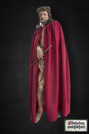Life-size, carved figure of Jesus with a red cloak on a dark background, 350-year-old processional figure in St Michael's Church, Neunkirchen am Brand, Middle Franconia, Bavaria, Germany, Europe