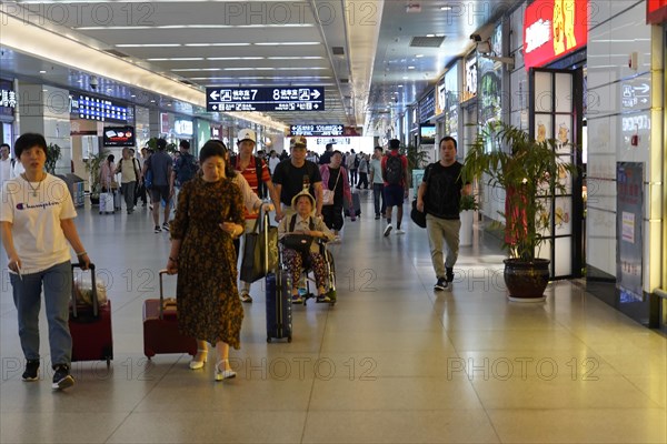 Hongqiao railway station, Shanghai, China, Asia, travellers with wheeled luggage in a well-lit airport interior, Yichang, Hubei province, Asia