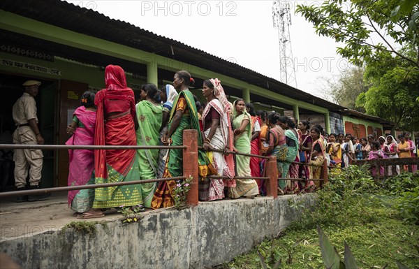BOKAKHAT, INDIA, APRIL 19: Voters wait in line at a polling station to cast their votes during the first phase of the India's general elections on April 19, 2024 in Bokakhat, Assam, India. Nearly a billion Indians vote to elect a new government in six-week-long parliamentary polls starting today