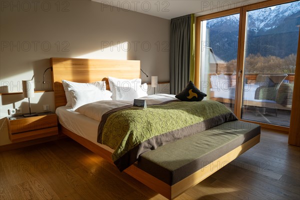 Modern furnished bedroom with large window and view of the mountains, Bad Reichenhall, Bavaria, Germany, Europe