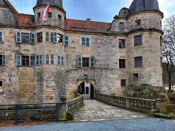 Mitwitz moated castle under a cloudy sky. Mitwitz, Kronach, Upper Franconia, Bavaria, Germany, Europe