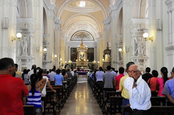 Catedral de la Asuncion, built in 1860, Leon, Nicaragua, People during a service inside a church looking towards the altar, Central America, Central America