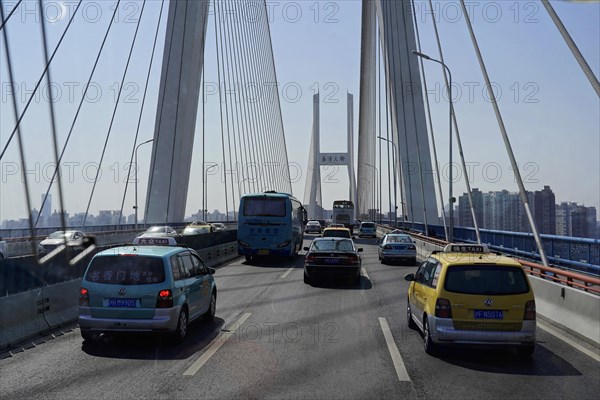Traffic in Shanghai, Shanghai Shi, People's Republic of China, Many vehicles drive over an impressive bridge in a big city, Shanghai, China, Asia