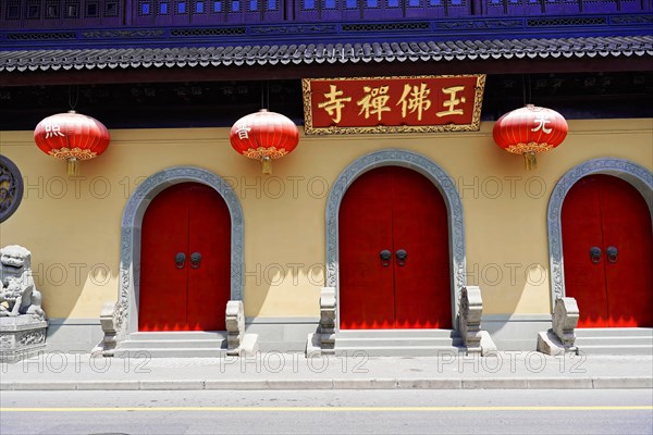 Jade Buddha Temple, Shanghai, Red doors and lanterns on a wall with traditional Chinese architecture, Shanghai, China, Asia