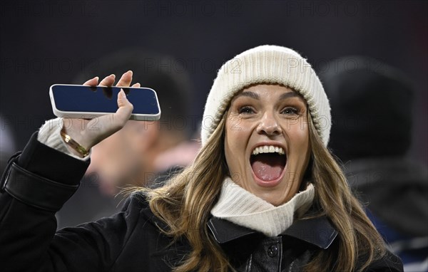 TV presenter Laura Wontorra DAZN, portrait, cap, laughs, waves to her fans, smartphone, mobile phone, Allianz Arena, Munich, Bavaria, Germany, Europe