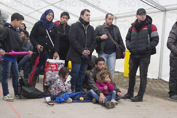 A Syrian refugee family and their children wait in a tent at the Berlin State Office for Health and Social Affairs for their registration, 15 October 2015, Berlin, Berlin, Germany, Europe