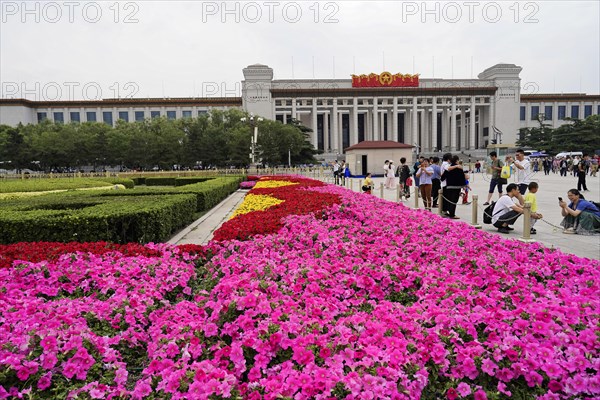 Beijing, China, Asia, Blooming flower beds in front of a large historic building in a busy city, Asia