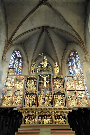 Kaysersberg, Alsace Wine Route, Alsace, Departement Haut-Rhin, France, Europe, A gilded wood carved altar with religious depictions and stained glass, Europe