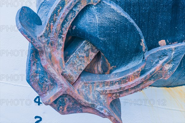 Closeup of ship metal anchor retracted into the hull of the ship in Yeosu, South Korea, Asia