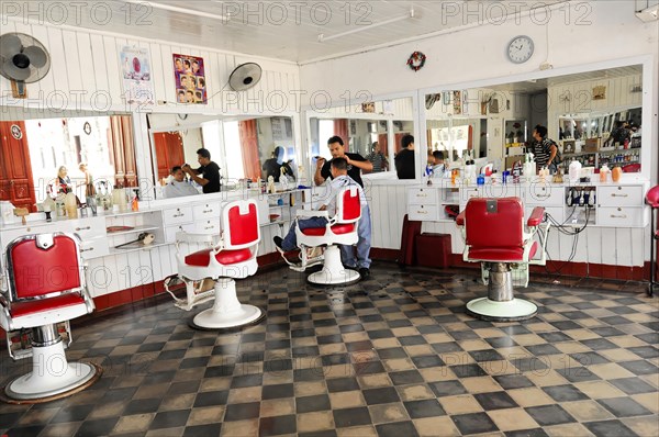 Granada, Nicaragua, Interior view of a traditional hairdressing salon with red and white barber chairs and chequered floor, Central America, Central America -, Central America