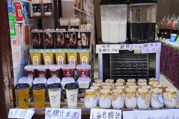 Excursion to Zhujiajiao water village, Shanghai, China, Asia, Wooden boat on canal with views of historic architecture, A stall offers a variety of tea drinks to choose from, Asia