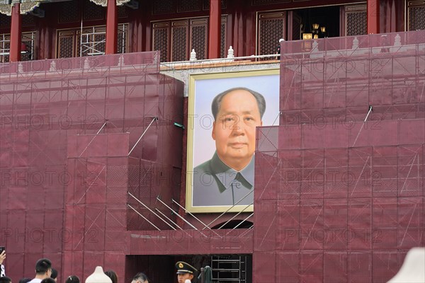 China, Beijing, Forbidden City, UNESCO World Heritage Site, A political portrait on the facade of a historic building undergoing renovation, Asia