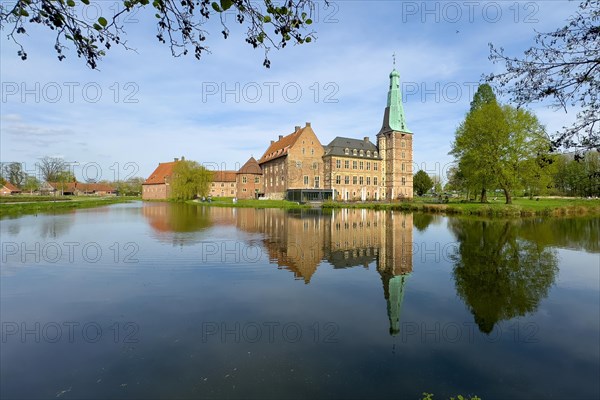 View over moat to historic moated castle from Renaissance Raesfeld Castle reflected in moat in spring, excursion destination in North Rhine-Westphalia, Freiheit Raesfeld, Muensterland, North Rhine-Westphalia, Germany, Europe