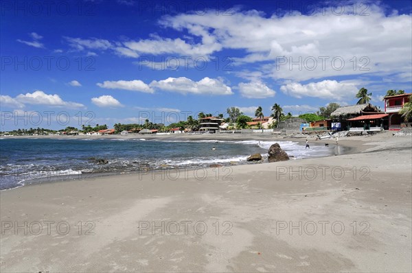Beach at Poneloya, Las Penitas, Leon, Nicaragua, Quiet beach view with village in the background under a clear blue sky, Central America, Central America