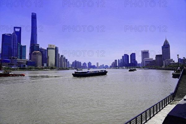 View from the Bund to the skyline at the Huangpu River with Oriental Pearl Tower, World Financial Centre, Shanghai Tower, Jin Mao Building in the Pudong district, Shanghai, China, Asia, Riverbank view of a skyline with skyscrapers on a clear day, Asia