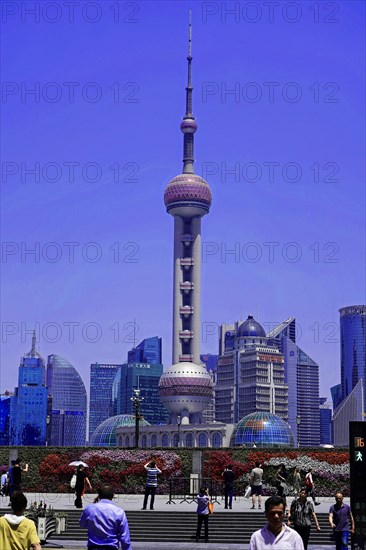 Stroll through Shanghai to the sights, Shanghai, China, Asia, The Shanghai Oriental Pearl Tower dominates the cityscape with people in the foreground, Asia