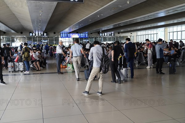 Hongqiao Railway Station, Shanghai, China, Asia, Travellers waiting in a brightly lit airport area, Yichang, Hubei Province, Asia
